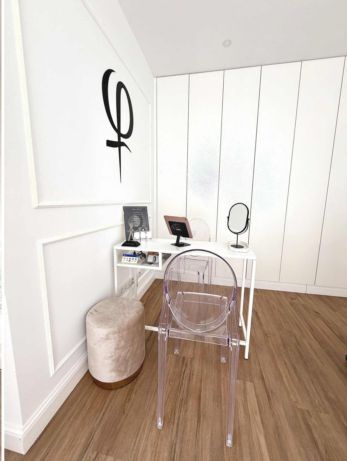 Consultation desk with Phi Academy signage and Ghost chair — Browboutique Cascais